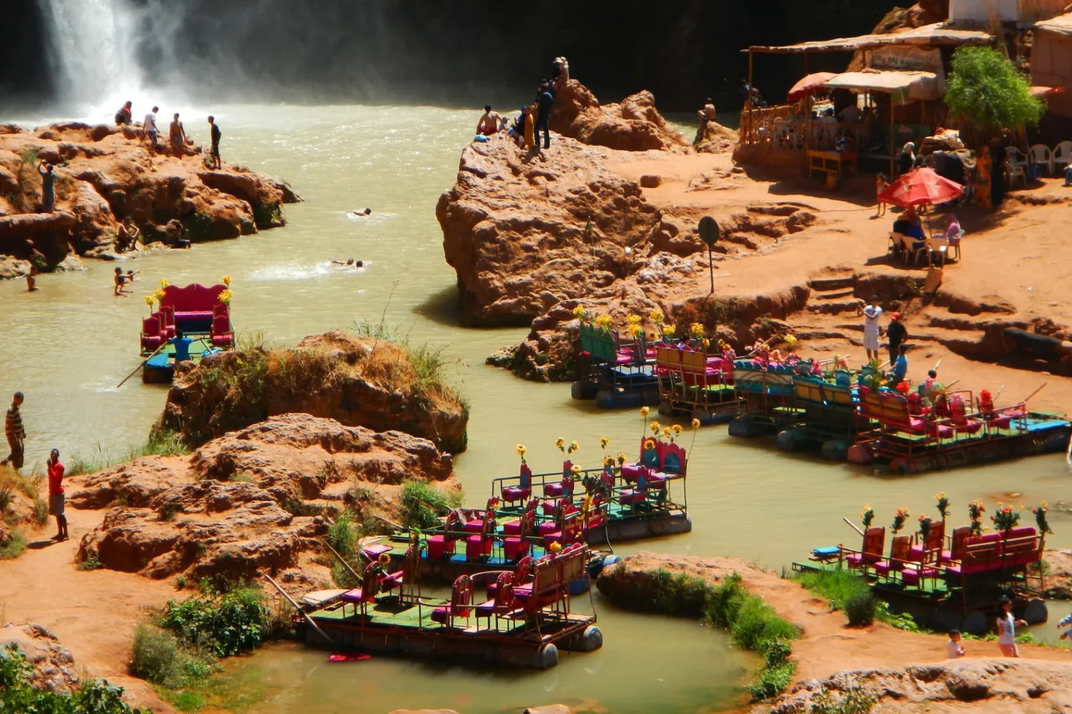 A diverse group of individuals enjoying leisure time together in a flowing river, surrounded by nature.